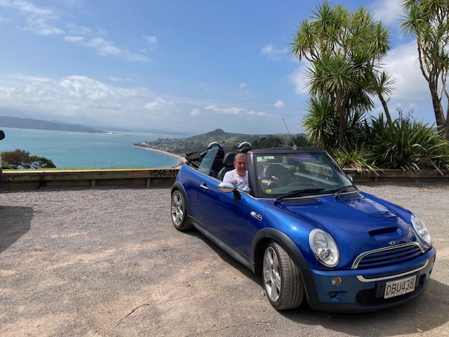 Customer in Mini Cooper S convertible by sea