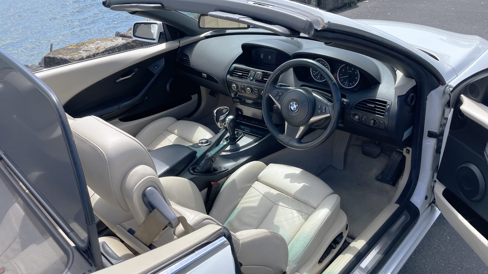 RentAClassics BMW 650 convertible interior showing drivers seat and wind deflector and dashboard