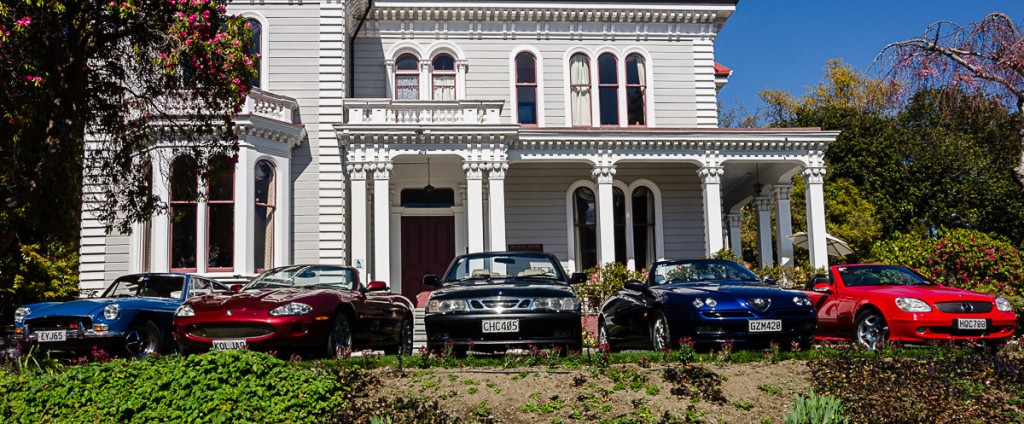 Five RentAClassic hire cars in front of Melrose House, Nelson