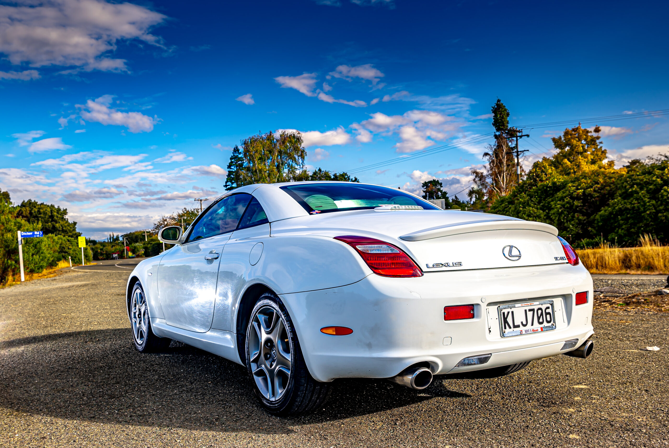 RentAClassics Lexus SC430 rear three quarters roof up under blue skies