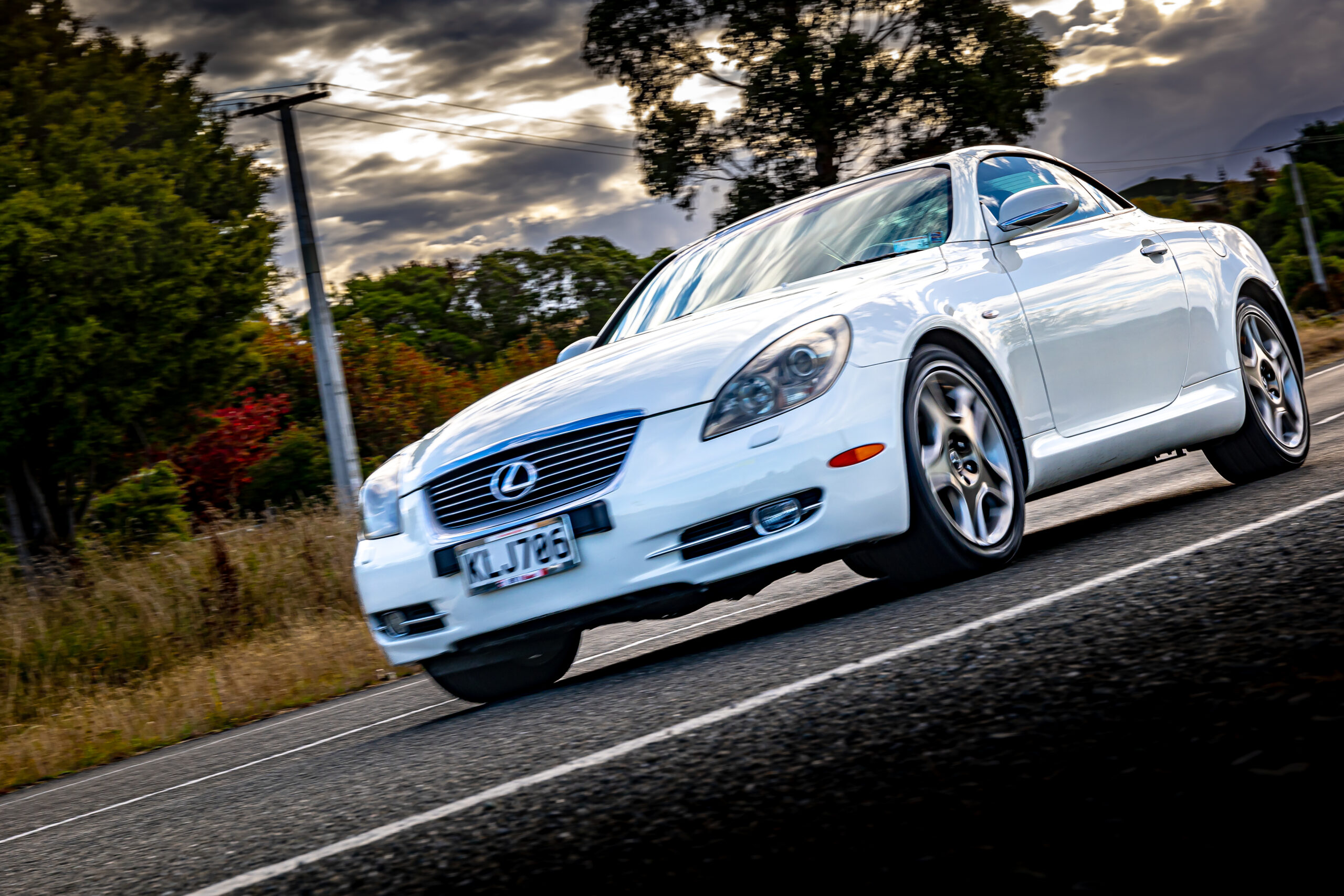 RentAClassics Lexus SC430 driving quick on road at angle